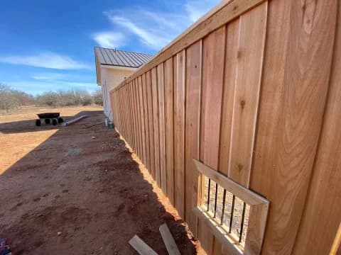 Dog viewing window in a wood privacy fence